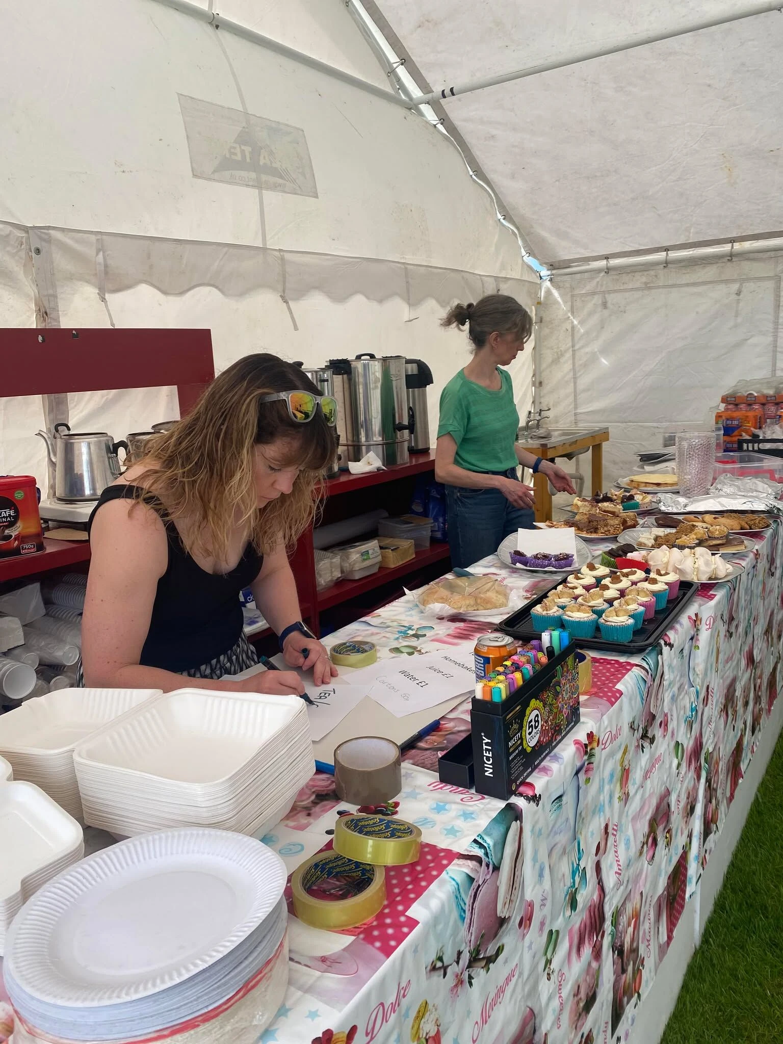 People together selling cakes at a fayre hosted by SYCC